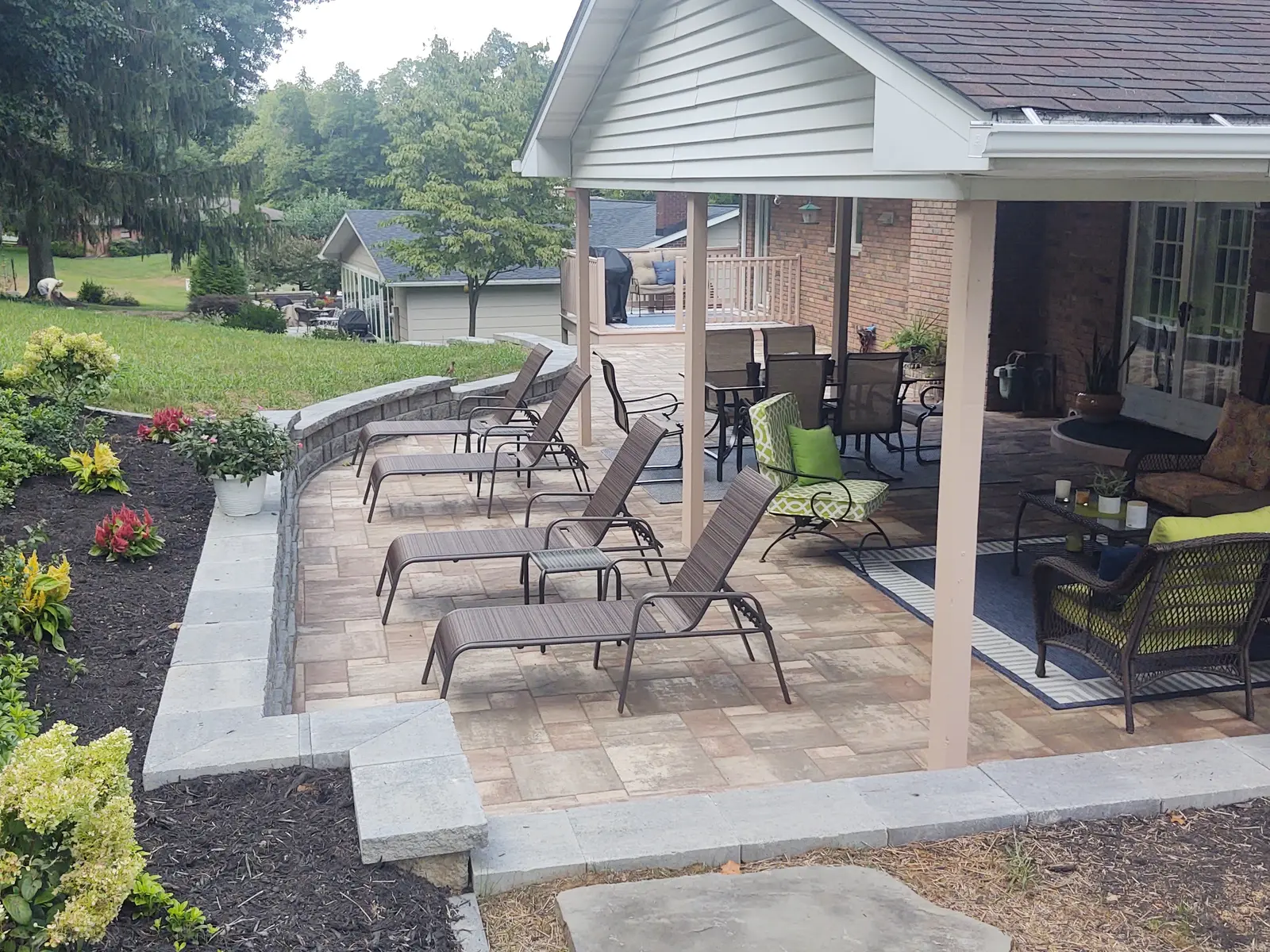 Outdoor lounge arranged on a multi-tone paver patio by Dave's Landscaping