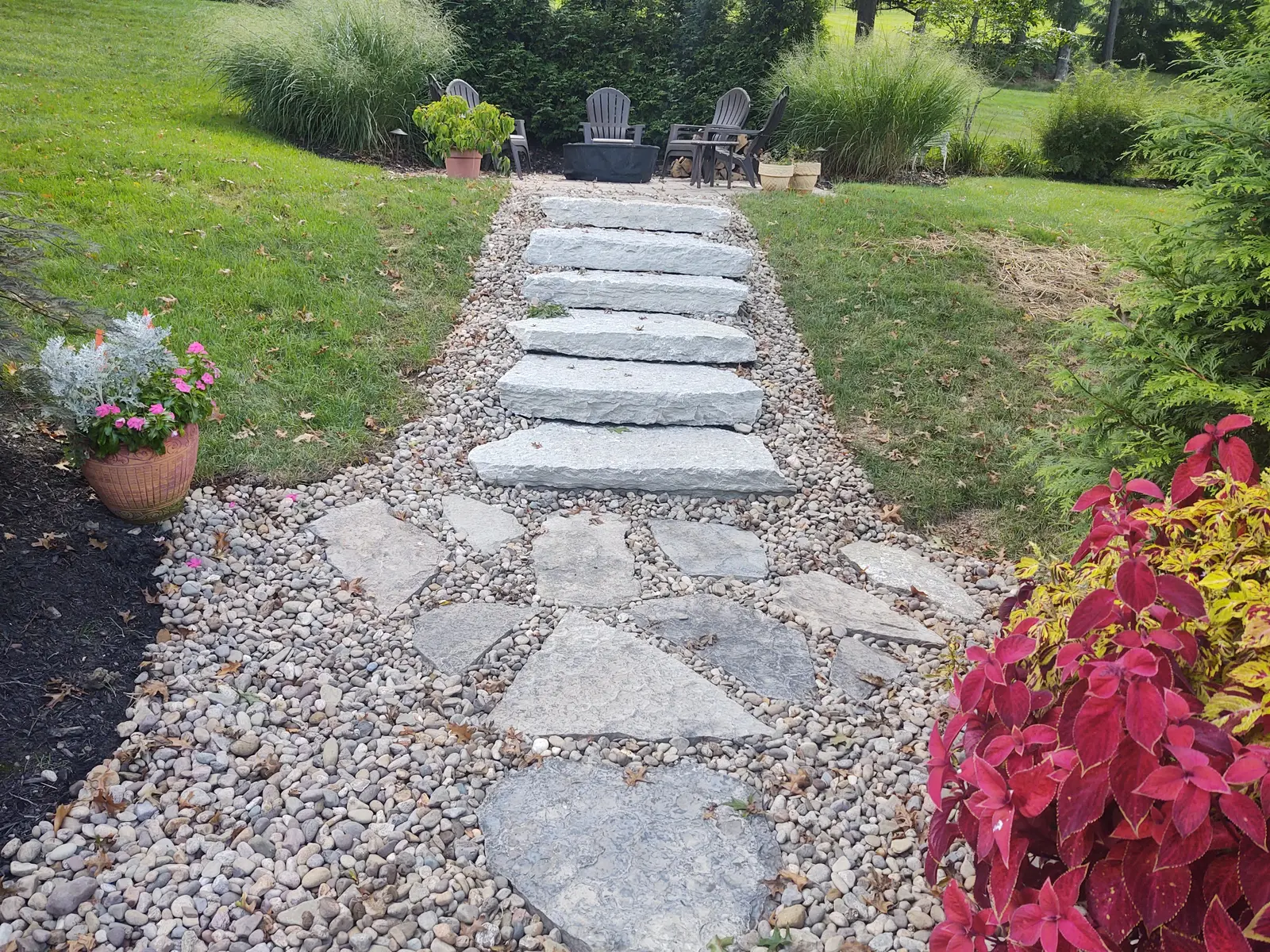 Fieldstone garden steps set into a gravel slope by Dave's Landscaping
