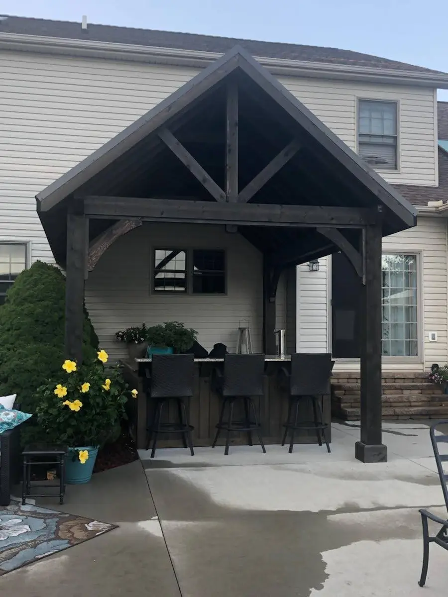 Timber gazebo and bar creating a covered backyard destination by Dave's Landscaping
