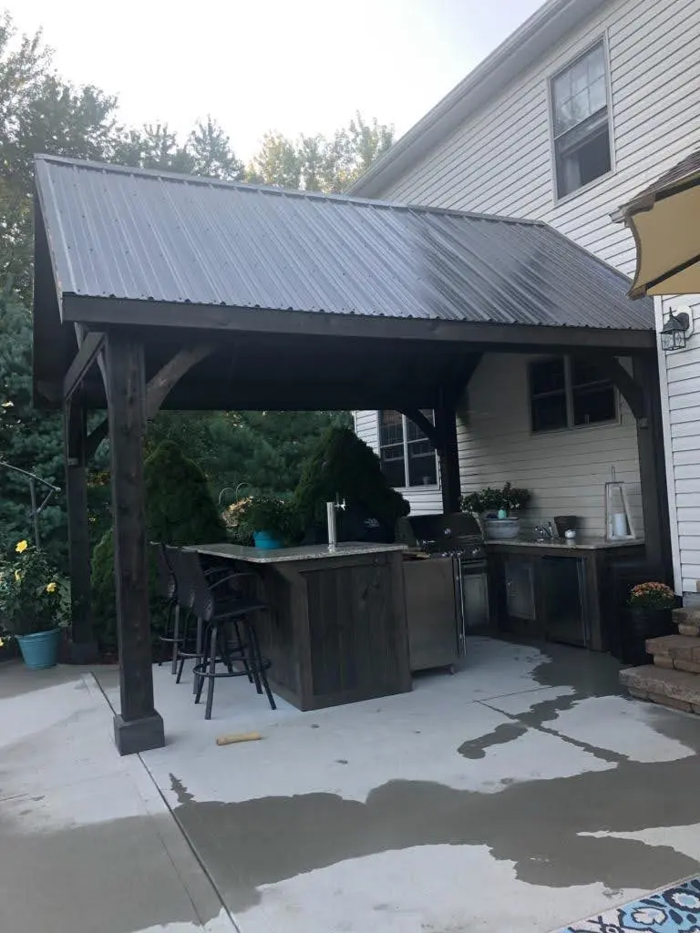 Compact timber gazebo with an integrated outdoor bar by Dave's Landscaping