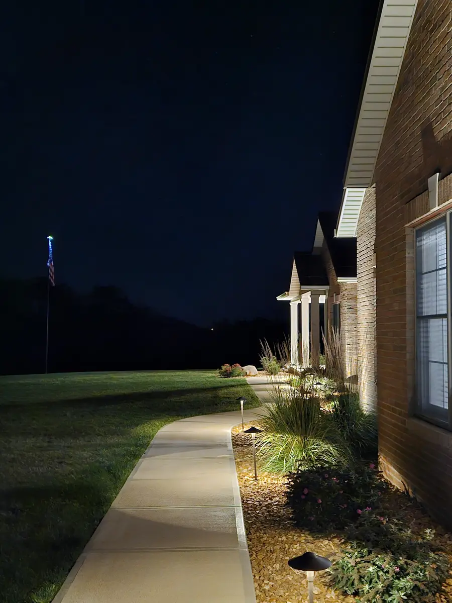 Subtle path lighting along a home and garden edge by Dave's Landscaping