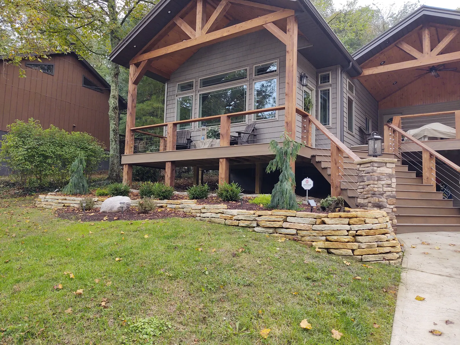 Tiered retaining walls and steps at a log home by Dave's Landscaping