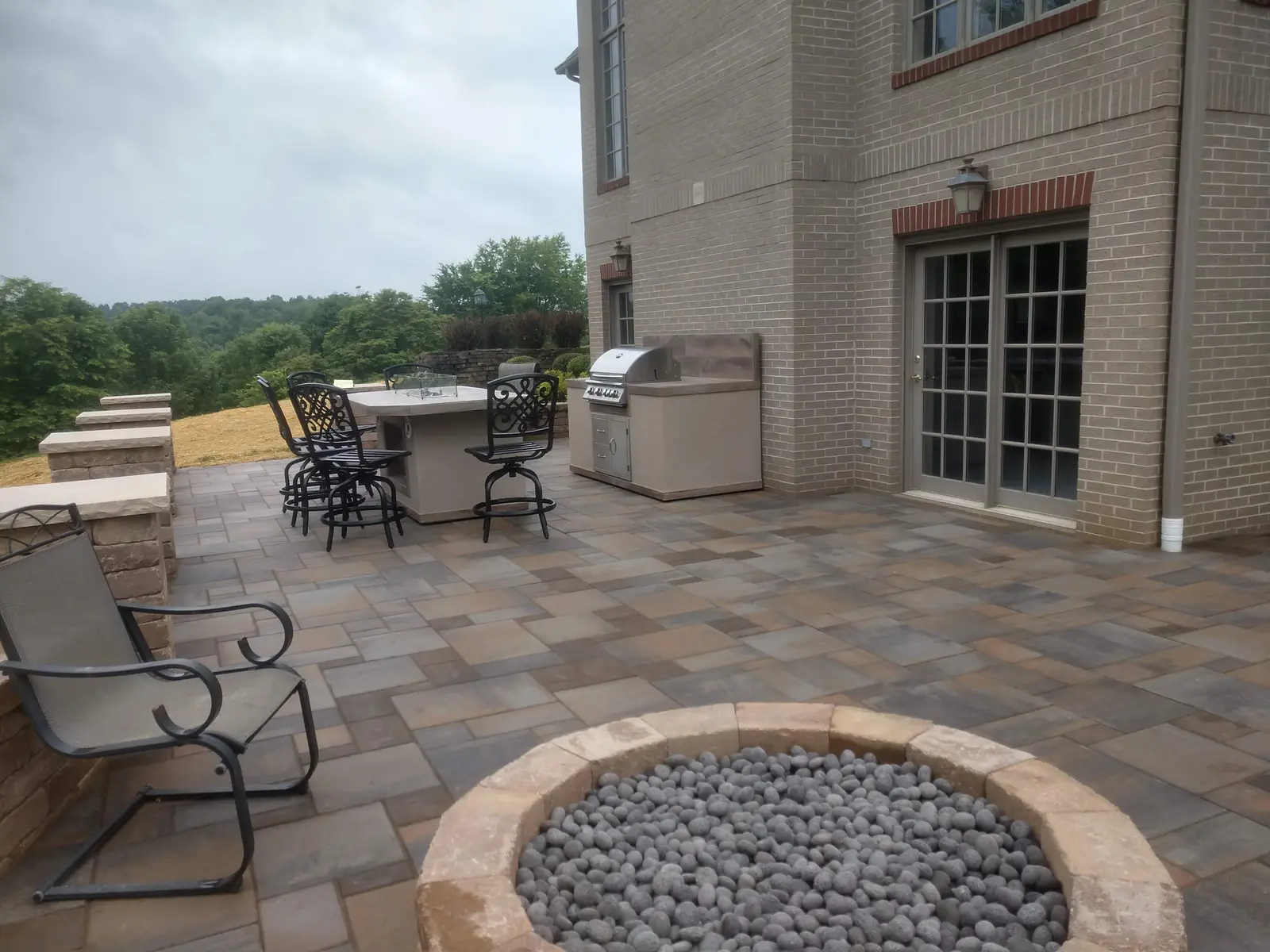 Fire pit terrace connected directly to the home by Dave's Landscaping