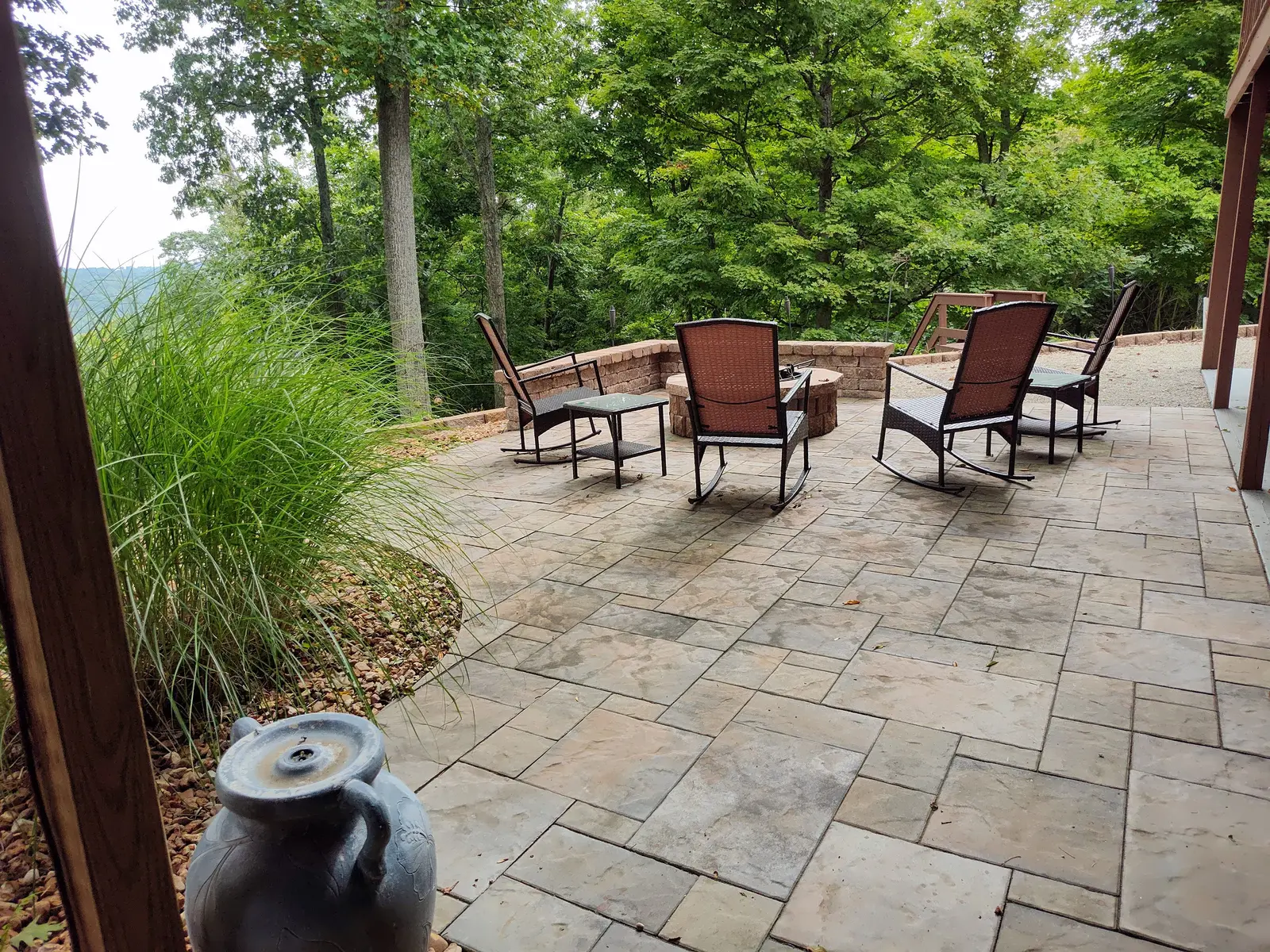 Quiet paver lounge framed by tall ornamental grasses by Dave's Landscaping